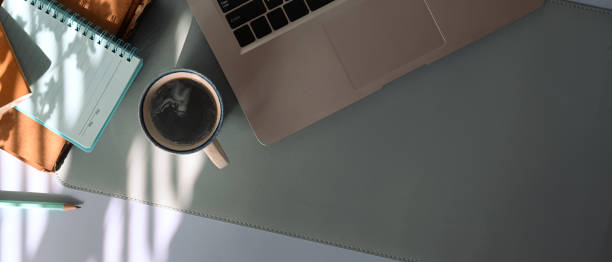 istock Above view office desk with laptop, coffee cup and notebook. 1317730766