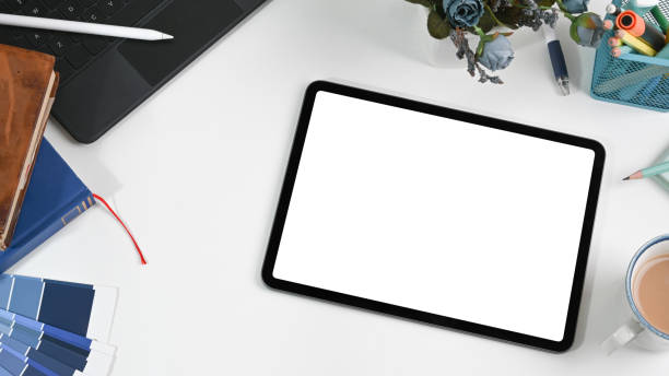 istock Flat lay. Graphic designer work table with digital tablet, stationery, coffee cup and color swatch. 1317731029