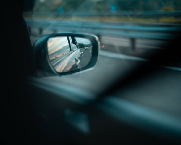 istock Car side mirror view in the highway. fast-moving automobile concept. side mirror view from the rear passenger sheet. 1317731244
