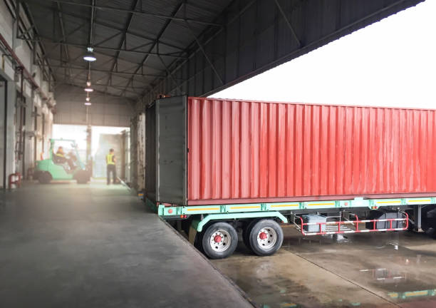 istock Trailer Trucks Parked Loading at Dock Warehouse. Shipping Warehouse Logistics.Cargo Shipment. Industry Freight Truck Transportation. 1317731976