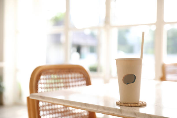 istock Iced coffee with paper glass in coffee shop background 1317732521