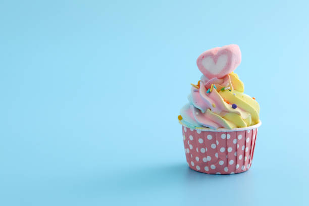 istock Colorful cupcake isolated in blue background 1317733292