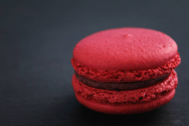 istock Colorful macarons isolated in black background 1317733425