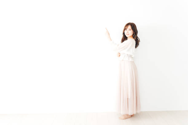 istock Young Woman Pointing with smile 1317734367