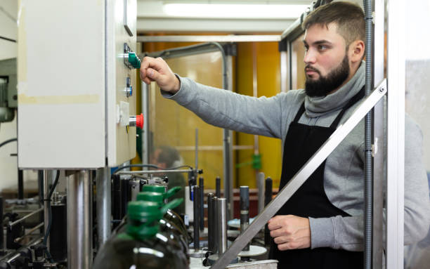 istock Guy pouring olive oil in plastic bottles 1317734689