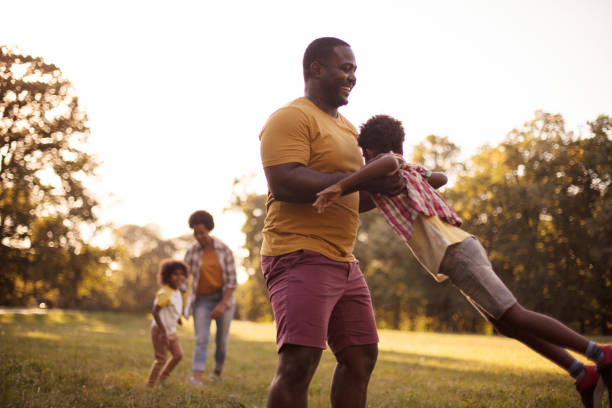 istock African American family having fun outdoors. Focus is on foreground. 1317734698
