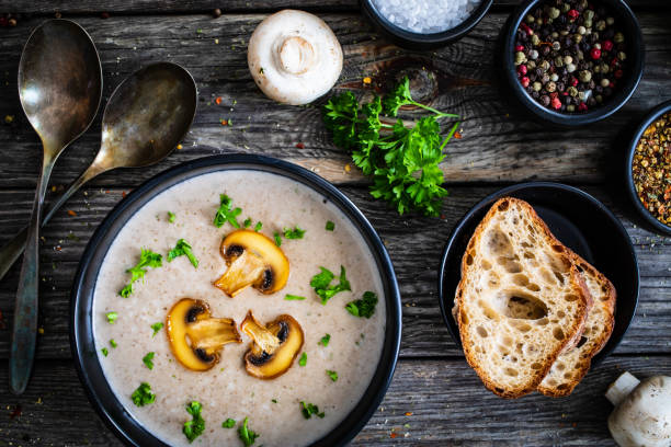 istock Cream white mushroom soup on wooden table 1317737696