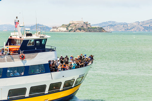 SAN FRANCISCO, CALIFORNIA, USA - July 24, 2018: View of the Alcatraz cruize boat with the tourists going to visit Alcatraz Island. Alcatraz was a federal prison from 1934 to 1963.