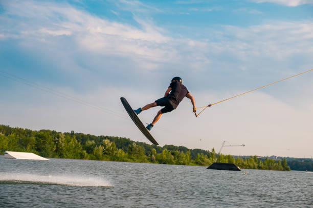 istock Young man jumping over water surface of river on wakeboard 1317738146