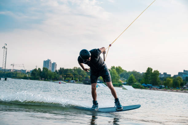 istock Man balancing on wakeboard on river surface in city 1317738265