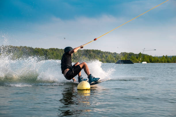 istock Wakeboarder making grab of board maneuvering between buoys 1317738309