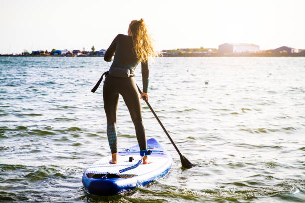 istock Female SUP paddle-boarding in ocean 1317739111