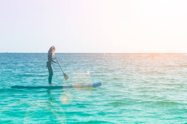 istock Female SUP paddle-boarding in ocean 1317739123