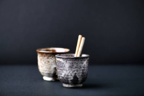 Traditional, handcrafted ceramic on dark background. Soft focus. Close up. Copy space.