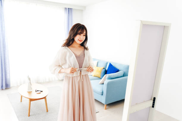 istock Young woman changing clothes at home 1317741095