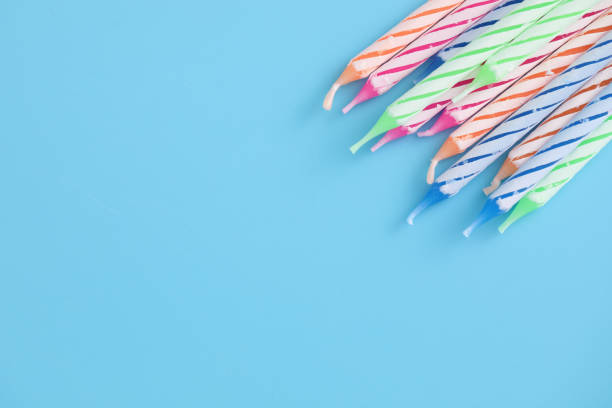 istock Colorful candles isolated in blue background 1317742327