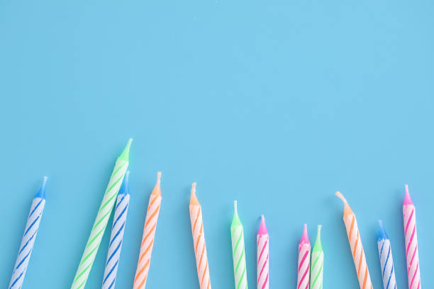 istock Colorful candles isolated in blue background 1317742460