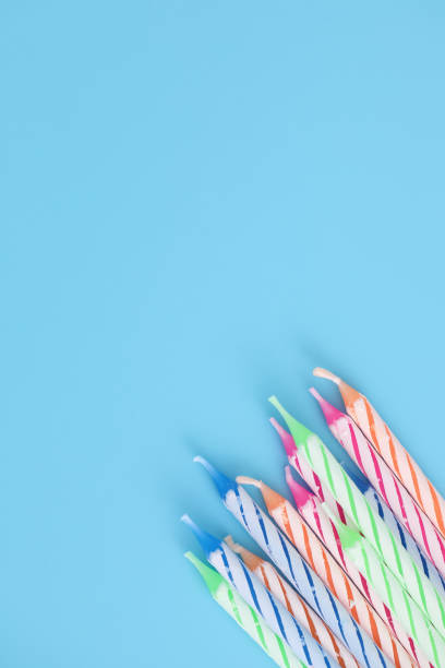 istock Colorful candles isolated in blue background 1317742529