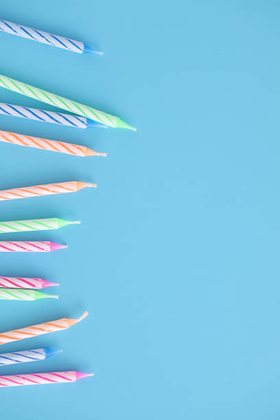 istock Colorful candles isolated in blue background 1317742576