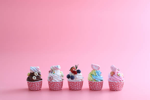 istock Colorful cupcakes isolated in pink background 1317742616