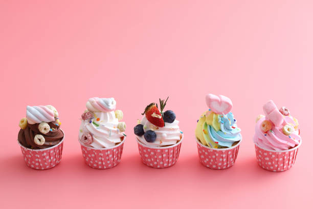 istock Colorful cupcakes isolated in pink background 1317742871