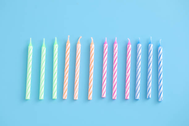istock Colorful candles isolated in blue background 1317743042