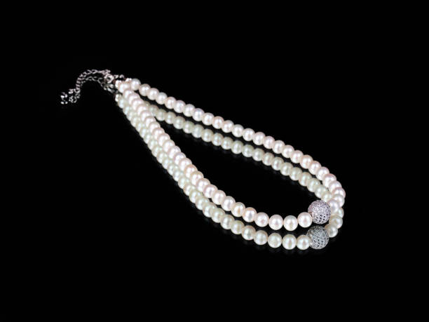 istock Luxury elegant baroque pearl silver necklace on black mirror background 1317743776