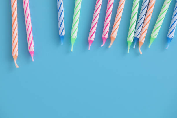 istock Colorful candles isolated in blue background 1317744050