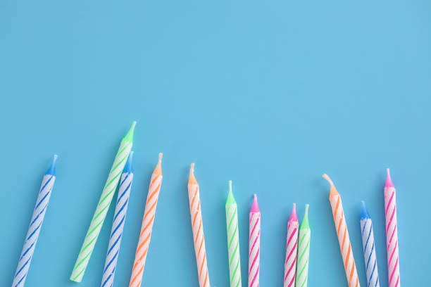istock Colorful candles isolated in blue background 1317744162