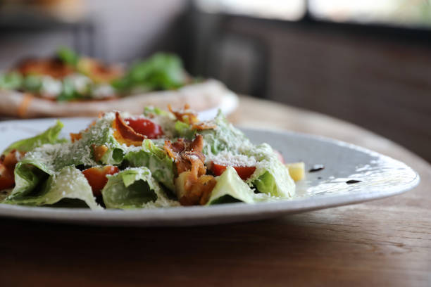 istock caesar salad appetizer on wooden background 1317744262