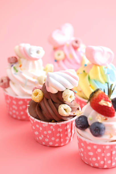 istock Colorful cupcakes isolated in pink background 1317744372
