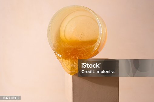 istock Liquid sugar wax flowing down from jar 1317745412