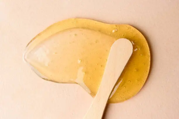 Photo of Liquid sugar wax smear with spatula