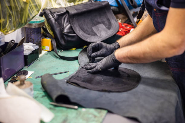 istock Wearing protective gloves and tracing shape around the leather piece for replacement 1317746965