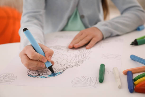 istock Child coloring drawing at table in room, closeup 1317748530
