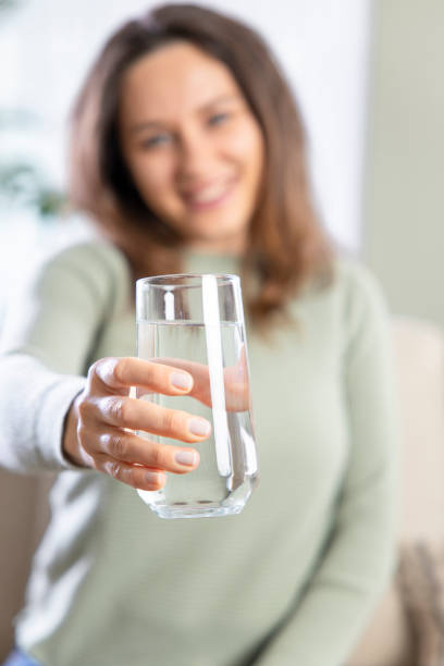 istock Woman drinking water at home 1317750006