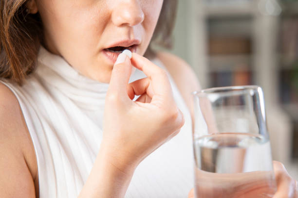 istock Young woman taking pill 1317750723