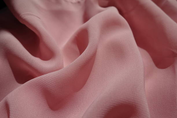 istock Thin pastel pink chiffon fabric in soft folds' 1317751545