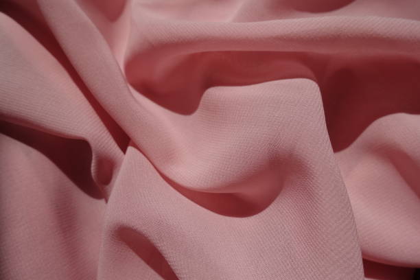 Pastel pink thin chiffon fabric in soft folds
