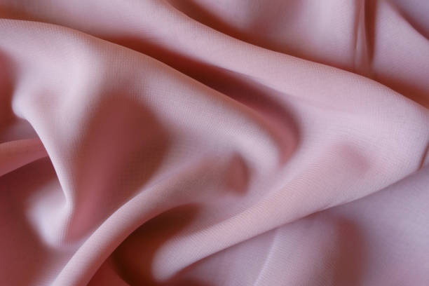 istock Light pink chiffon fabric in soft folds 1317751555