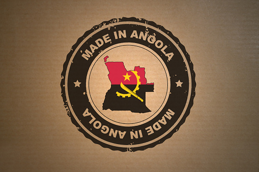 Brown paper with in its middle a retro style stamp Made in Angola include the map and flag of Angola.
