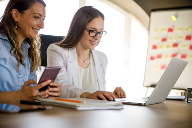 istock Two businesswomen working on a fun project at the office 1317753764