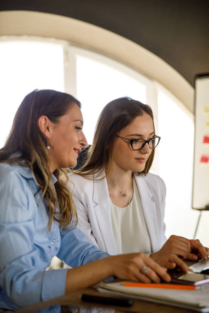 istock Two diligent businesswomen collaborating on a fun project together 1317753905