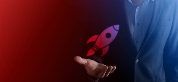 istock Start up concept with businessman holding abstract digital rocket icon rocket is launching and soar flying. 1317757681