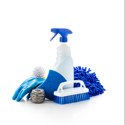 Front view of various cleaning products such as a spray, a rubber glove, a scrubbing brush, and a cleaning sponge isolated on white background. Studio shot taken with Canon EOS 6D Mark II and Canon EF 24-105mm f/4L