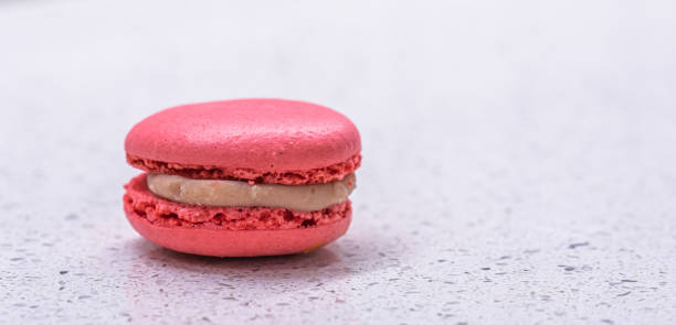 istock French cake macaron on white background. Tasty fruit, almond sweet cookie 1317758037