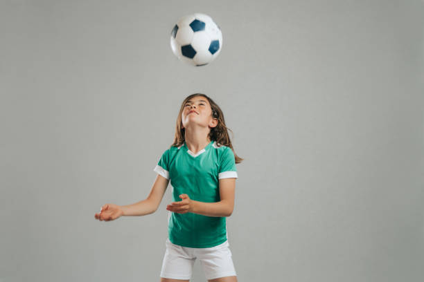 istock Girl posing with soccer ball 1317759100