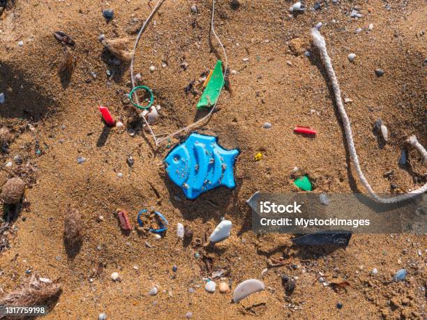 Plastic Fish And Micro Plastic On Beach Stock Photo - Download Image Now - Microplastic, Sea, Climate Change