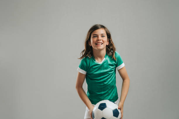 istock Girl posing with soccer ball 1317759315
