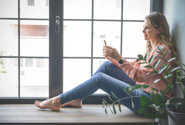 istock attractive middle aged woman in the office ( mobile phone) 1317760270